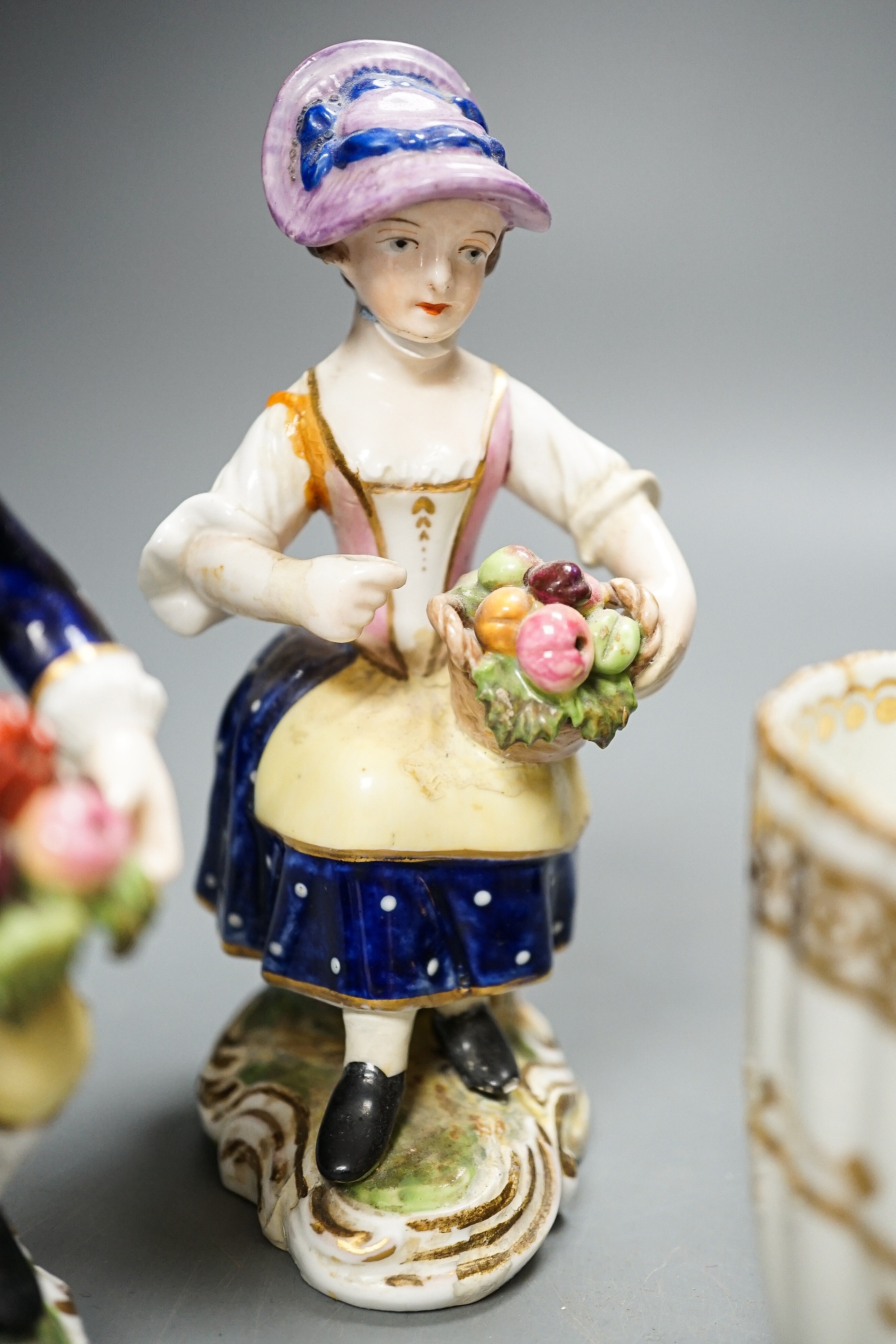 A Derby Imari saucer, a similar tea cup, a pair of Sampson Hancock, Derby figures, and a Derby cup, tallest figure 13 cms high.